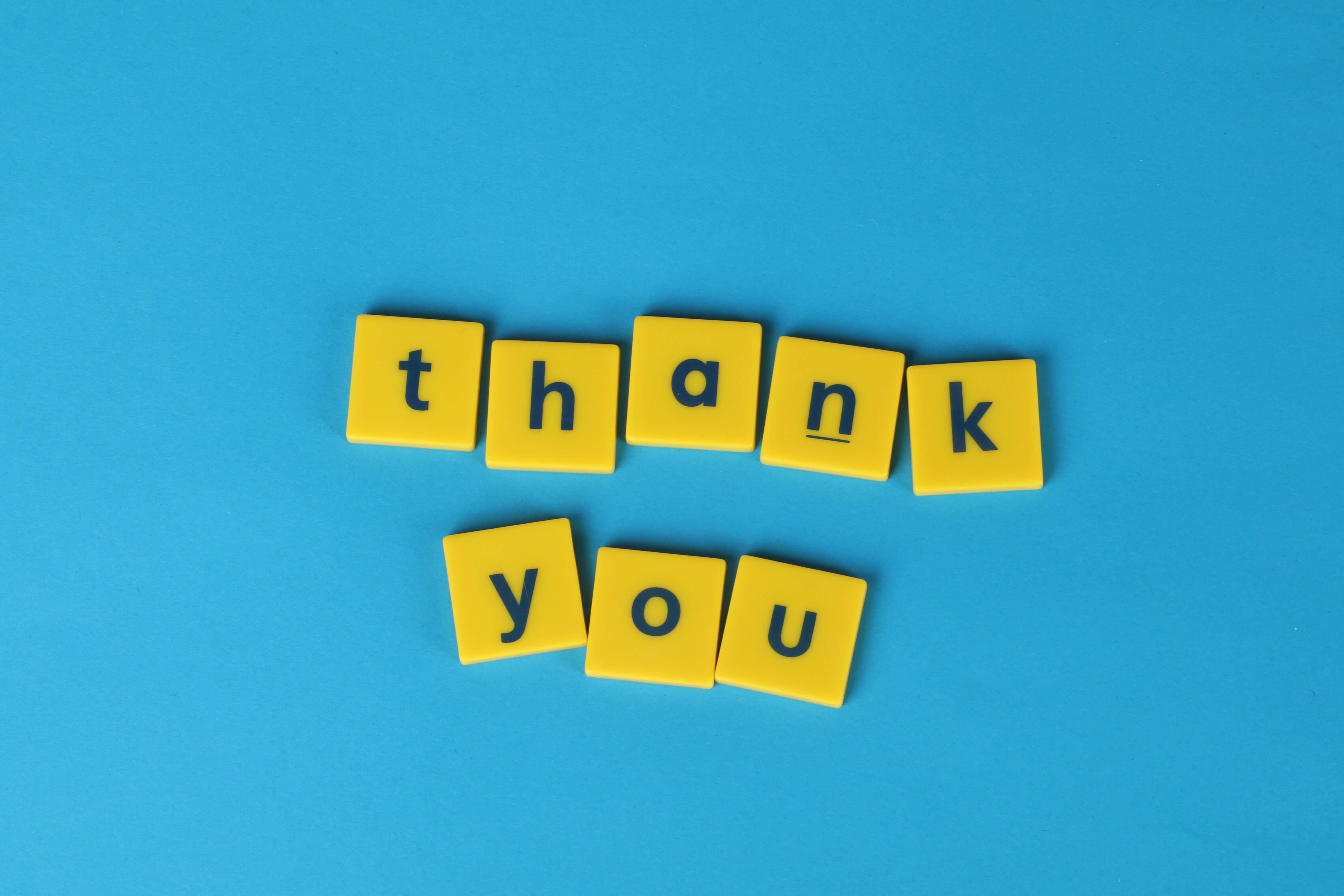 thank you yellow letters on a blue background