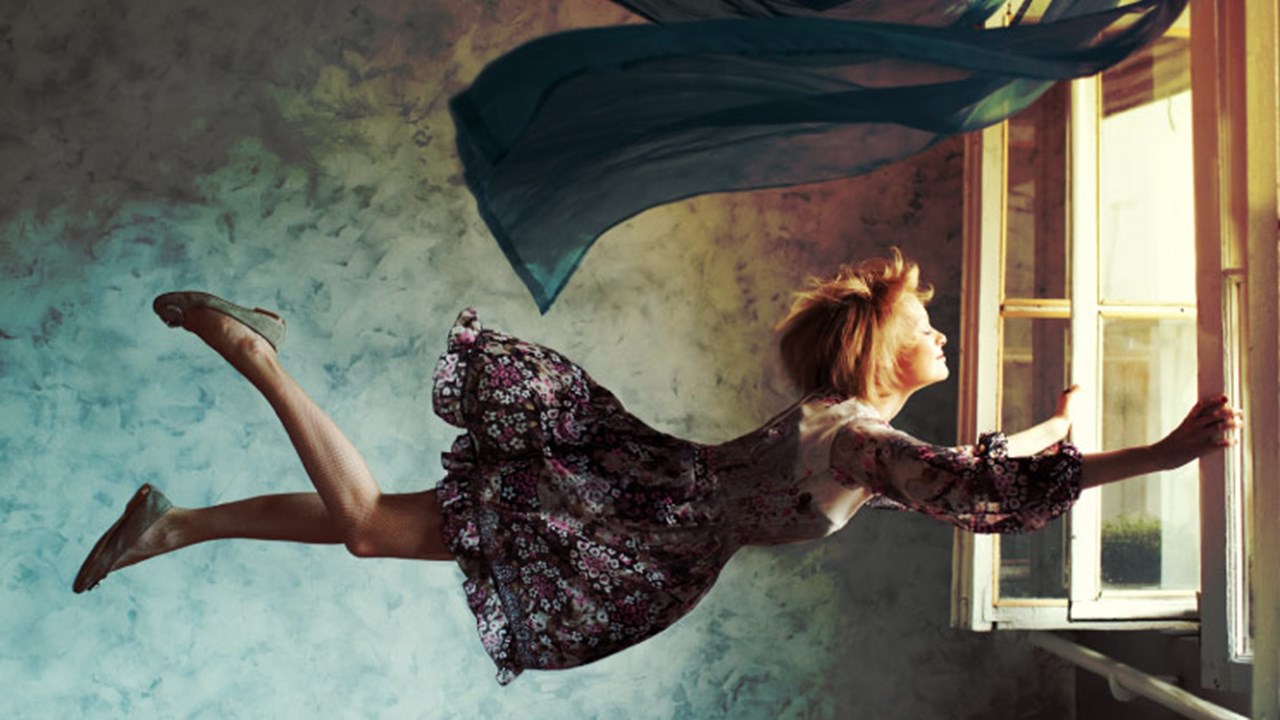 Young woman flying.