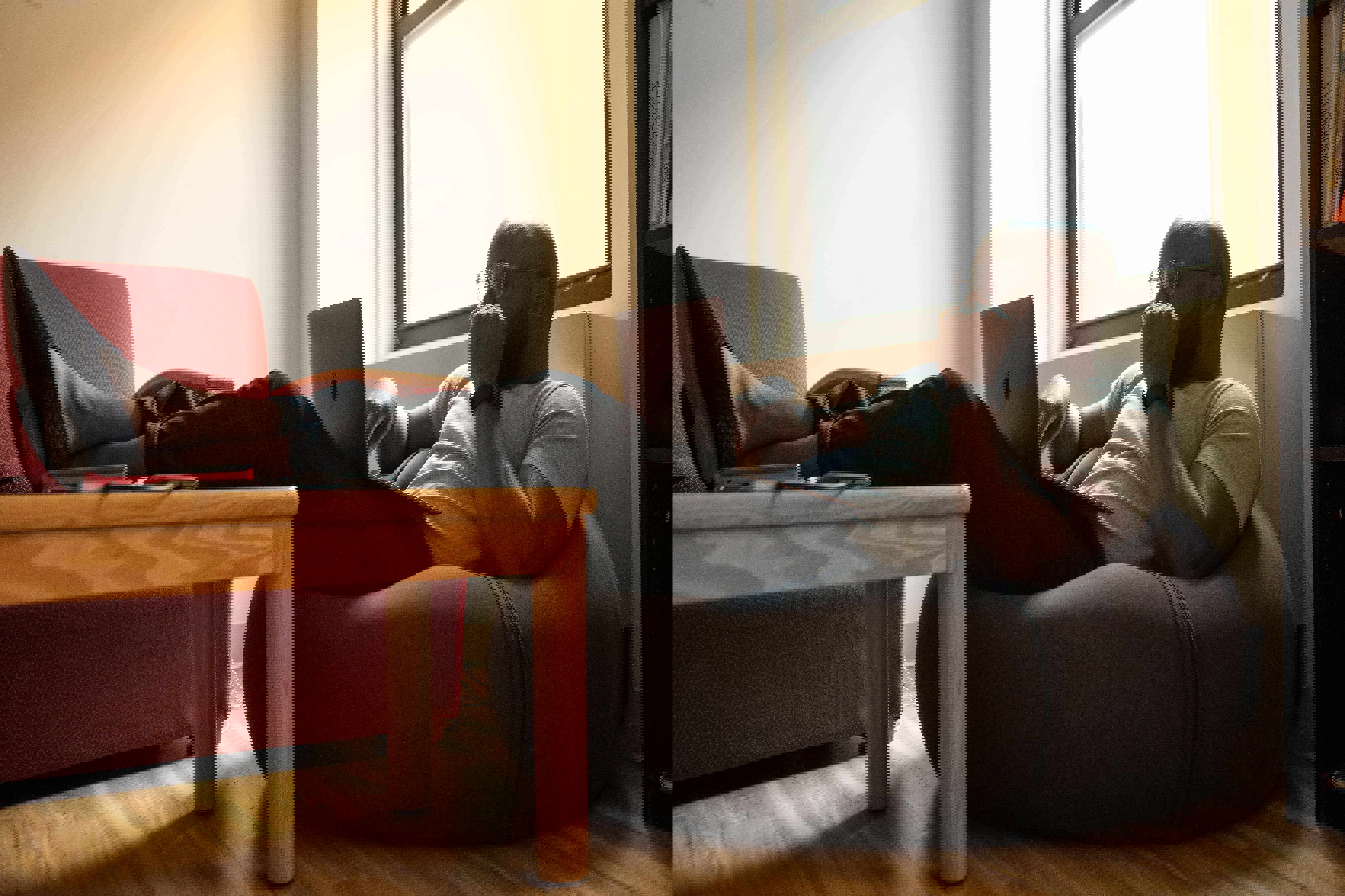 man sitting on a beanbag with laptop