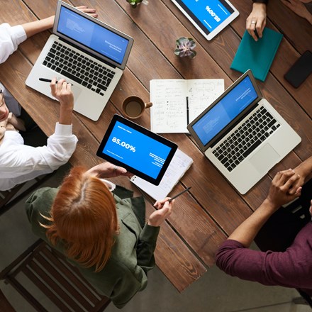 Top View Photo Of Group Of People Using Laptop