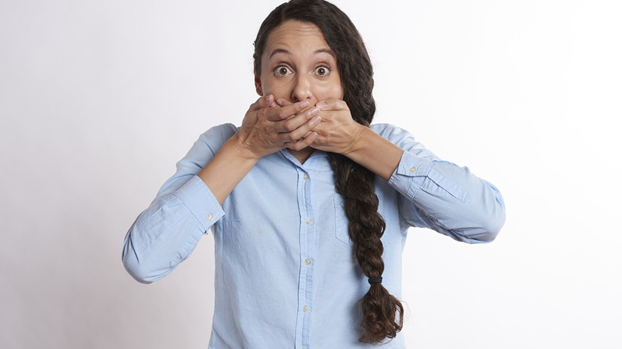 Woman covering mouth in shock